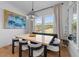 Bright dining room boasts a modern light fixture, stylish seating, and ample natural light at 105 Scotland Dr, Youngsville, NC 27596