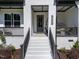 Charming home entrance with brickwork, manicured landscaping, and inviting front porch at 105 Scotland Dr, Youngsville, NC 27596