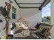 Cozy front porch featuring egg chairs, plants, and patterned rugs for outdoor relaxation at 105 Scotland Dr, Youngsville, NC 27596