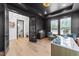 Modern home office boasts an accent wall, natural light, modern desk and wood flooring at 105 Scotland Dr, Youngsville, NC 27596