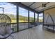 Relaxing screened-in patio with hanging chair, outdoor dining, and scenic backyard views at 105 Scotland Dr, Youngsville, NC 27596