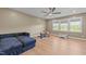 Bright playroom with a dark blue sectional couch, windows with a view, and a round table at 105 Scotland Dr, Youngsville, NC 27596