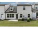 Exterior backyard view of a two-story house with a small patio and green lawn at 107 Explorer Dr, Morrisville, NC 27560