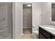 Modern bathroom featuring a walk-in shower with gray tiles and a granite countertop vanity at 107 Explorer Dr, Morrisville, NC 27560