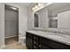 Bathroom with a double sink vanity, granite counters, and a glass-enclosed shower at 107 Explorer Dr, Morrisville, NC 27560