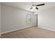 Bright bedroom with carpet, ceiling fan, and a window overlooking the yard at 107 Explorer Dr, Morrisville, NC 27560