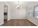 Elegant dining room features hardwood floors, a modern chandelier, and large windows at 107 Explorer Dr, Morrisville, NC 27560
