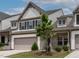 Two-story townhome showcasing a covered brick front porch with a two-car garage at 107 Explorer Dr, Morrisville, NC 27560