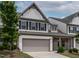 Charming two-story townhome with a well-manicured lawn and a two-car garage at 107 Explorer Dr, Morrisville, NC 27560