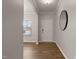 Bright foyer with hardwood floors, a round mirror, white trim, and a view into the living area at 107 Explorer Dr, Morrisville, NC 27560