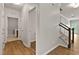 View of hallway with hardwood floors, staircase, and doorways leading to other rooms of the house at 107 Explorer Dr, Morrisville, NC 27560
