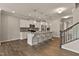 Spacious kitchen with white cabinets, granite countertops, stainless steel appliances and a large island at 107 Explorer Dr, Morrisville, NC 27560