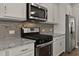 Close up of the kitchen area featuring stainless steel appliances, granite countertops, and custom cabinetry at 107 Explorer Dr, Morrisville, NC 27560
