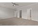Spacious main bedroom featuring a ceiling fan, carpeted floors, and multiple doorways at 107 Explorer Dr, Morrisville, NC 27560