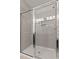 Tiled shower stall with glass enclosure, modern fixtures, and built-in shelves at 107 Explorer Dr, Morrisville, NC 27560