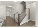 Open-concept staircase with modern wood and white railing, leading to the upper level at 107 Explorer Dr, Morrisville, NC 27560