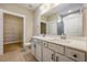 Bathroom with dual sinks, quartz countertop, tile flooring, and a door leading to a closet at 1087 Fairhaven Dr # 48, Mebane, NC 27302