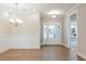 Elegant foyer featuring paneled walls, a decorative chandelier, and a welcoming front door with sidelights at 1087 Fairhaven Dr # 48, Mebane, NC 27302