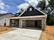 Charming new construction home with a two-car garage and brick accents under a bright sky at 1087 Fairhaven Dr # 48, Mebane, NC 27302