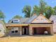 New construction features a brick exterior, attached garage, and unfinished landscaping under a clear blue sky at 1087 Fairhaven Dr # 48, Mebane, NC 27302