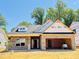 New construction features a brick exterior, attached garage, and unfinished landscaping under a clear blue sky at 1087 Fairhaven Dr # 48, Mebane, NC 27302