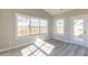 Sunlit living room with hardwood floors, large windows, and access to the yard through a glass door at 1087 Fairhaven Dr # 48, Mebane, NC 27302