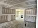 A spacious room with fireplace awaits finishing touches, promising a cozy living space at 1087 Fairhaven Dr # 48, Mebane, NC 27302