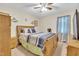 This cozy bedroom features neutral walls, carpet, a ceiling fan, and light-colored wooden furniture at 109 Grange Dr, Wendell, NC 27591