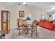 Open dining area featuring a vaulted ceiling, a round table, and access to the living area at 109 Grange Dr, Wendell, NC 27591