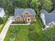 Aerial view of an attractive brick house with manicured lawn and mature landscaping at 112 Sterling Ridge Way, Cary, NC 27519