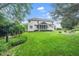 Sprawling, landscaped backyard with mature trees, screened in porch and fire pit area at 112 Sterling Ridge Way, Cary, NC 27519