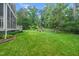 Backyard with wooden playset and fire pit, accessible from an enclosed back porch at 112 Sterling Ridge Way, Cary, NC 27519