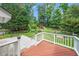 Expansive backyard features a playset, fire pit, patio, wooden deck, and lush greenery at 112 Sterling Ridge Way, Cary, NC 27519