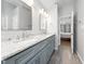 Gray bathroom vanity featuring double sinks, gray cabinets and white granite countertop in neutral toned bathroom at 112 Sterling Ridge Way, Cary, NC 27519