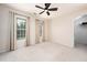Neutral toned bedroom featuring two windows with curtains, ceiling fan and light carpet at 112 Sterling Ridge Way, Cary, NC 27519