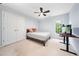 Light blue bedroom featuring a wood frame bed, white closet doors and light neutral carpet at 112 Sterling Ridge Way, Cary, NC 27519