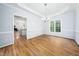 Bright dining room with hardwood floors, modern chandelier and large window at 112 Sterling Ridge Way, Cary, NC 27519