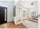 Bright exercise room with hardwood floors, natural light, and pilates reformer through french doors at 112 Sterling Ridge Way, Cary, NC 27519