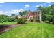 Beautiful two-story brick home featuring a well-maintained lawn, mature trees, and inviting curb appeal at 112 Sterling Ridge Way, Cary, NC 27519
