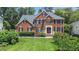 Charming brick home featuring a manicured front lawn, lush landscaping, and classic architectural details at 112 Sterling Ridge Way, Cary, NC 27519