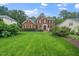 Lovely brick home with a well-manicured front lawn, mature landscaping, and a welcoming facade at 112 Sterling Ridge Way, Cary, NC 27519
