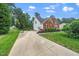 Inviting brick home with a long driveway, attached garage, and beautifully landscaped front yard at 112 Sterling Ridge Way, Cary, NC 27519