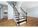 Elegant staircase featuring wood treads and decorative iron railings, complemented by hardwood floors at 112 Sterling Ridge Way, Cary, NC 27519