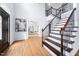Open foyer with hardwood floors, staircase with iron spindles, and front door at 112 Sterling Ridge Way, Cary, NC 27519