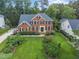 Traditional brick home with a well-manicured lawn and symmetrical landscaping at 112 Sterling Ridge Way, Cary, NC 27519