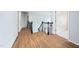 Well lit hallway with hardwood floors and decorative railing at 112 Sterling Ridge Way, Cary, NC 27519