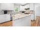 Kitchen with stainless steel appliances, white cabinets, granite countertops, and center island at 112 Sterling Ridge Way, Cary, NC 27519
