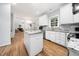 Bright kitchen featuring white cabinets, granite countertops, stainless appliances, and center island at 112 Sterling Ridge Way, Cary, NC 27519