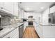 Kitchen features stainless steel appliances, granite countertops and white cabinets at 112 Sterling Ridge Way, Cary, NC 27519