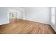 Bright room with hardwood floors, neutral paint, and an open doorway to dining area with chandelier at 112 Sterling Ridge Way, Cary, NC 27519
